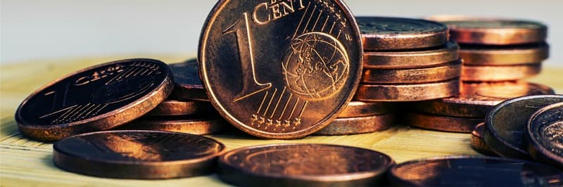 One Eurocent coin on the background of coins.
