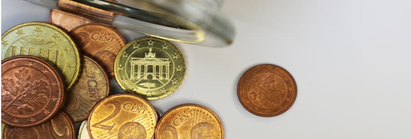 One Eurocent coin on the background of coins.